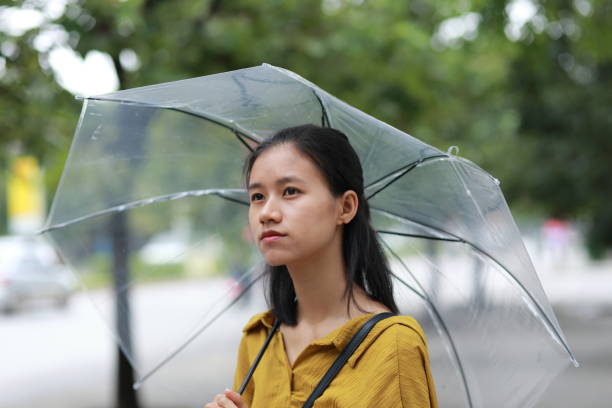 istock woman with umbrella in town 1153234731