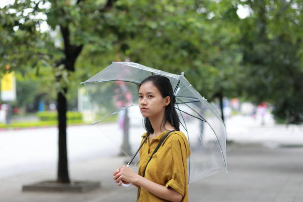 istock woman with umbrella in town 1153234778