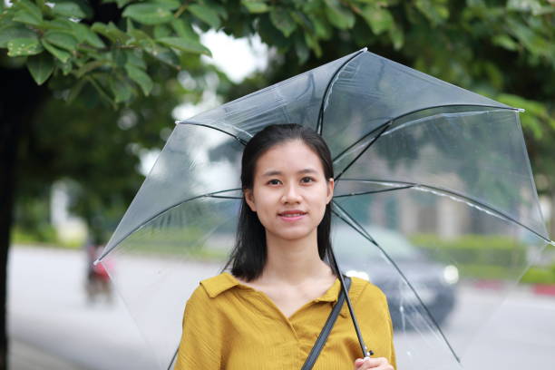 istock woman with umbrella in town 1153234808