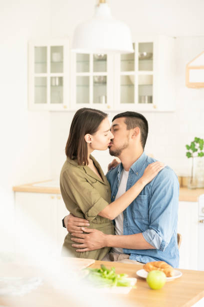 istock Kissing in the kitchen 1153234880
