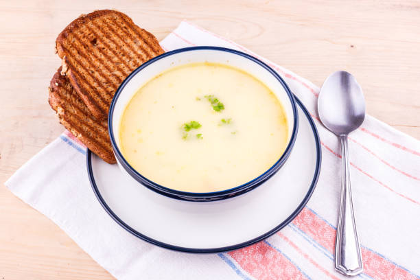 istock Cheese soup in a white plate with toasted bread 1153235367