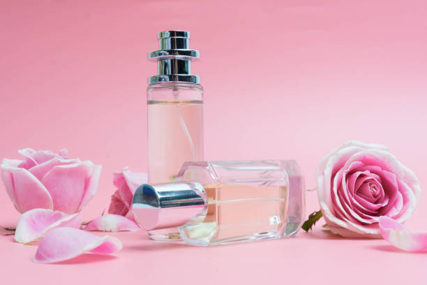 istock Beautiful perfume bottles on pink background 1153236209