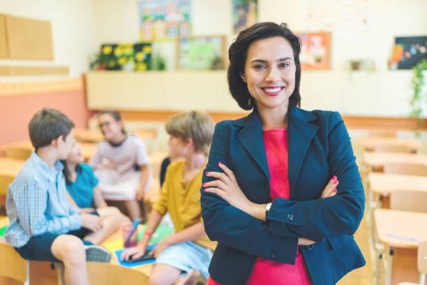 istock Portrait of young teacher in class teaching the students 1153236359