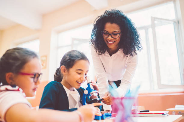 istock School children with mixed race teacher in class 1153236523