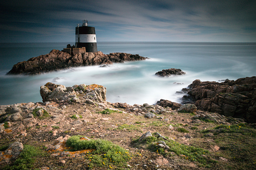 Long exposure photograph of Noirmont Point, located on the South coast of Jersey in the Channel Islands. This is an important landmark and navigation aid for shipping approaching the port of St. Helier.