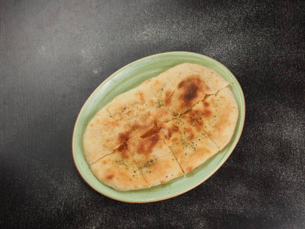 istock Cut pita bread on a plate 1153238723