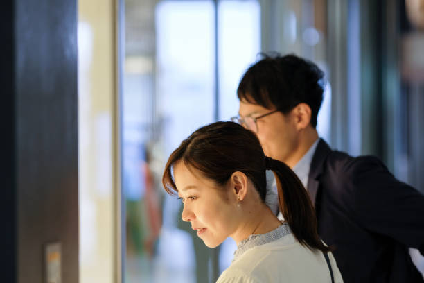 istock Couple looking at show window on street 1153240873
