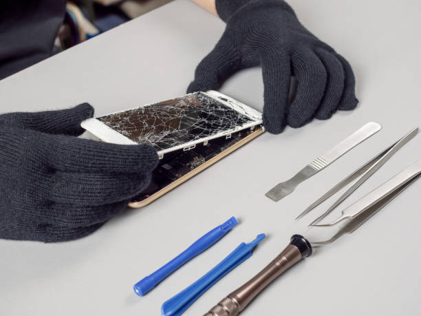 istock Technician repairing broken smartphone on desk 1153241383