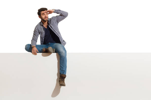 istock Handsome Man Is Sitting On A Top And Watching 1153241524