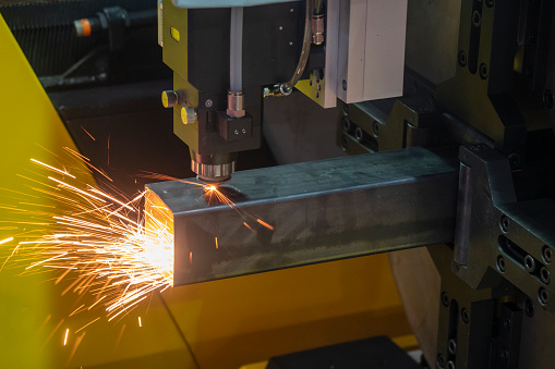 The CNC fiber laser cutting machine make engraving at the square stainless tube.  The hi-technology sheetmetal manufacturing process.