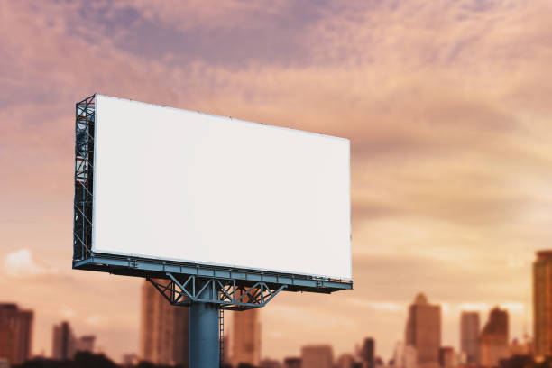 istock Blank billboard mockup with white screen against cloudy and city background. Copy space banner for advertisement. Business Concept. 1153244705
