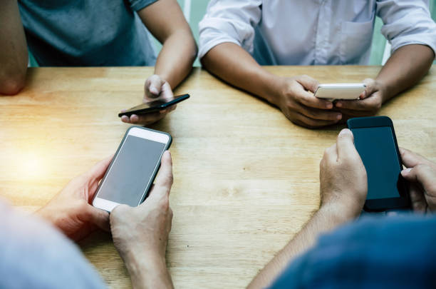 istock group of friends or young people hands using smart phone playing social networking sitting on table at home office, digital technology, WiFi internet, network connection and relationship concept 1153244744