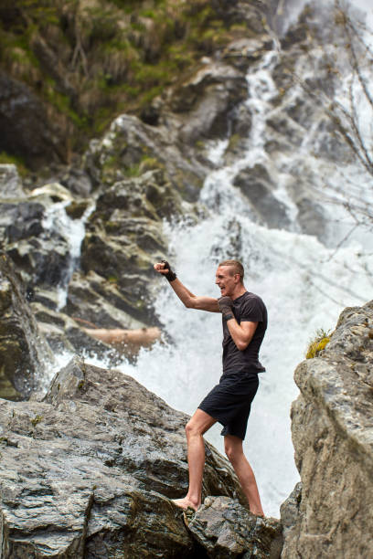 istock Muay thai fighter training by the waterfall 1153245028