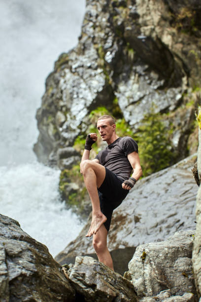 istock Muay thai fighter training by the waterfall 1153245086