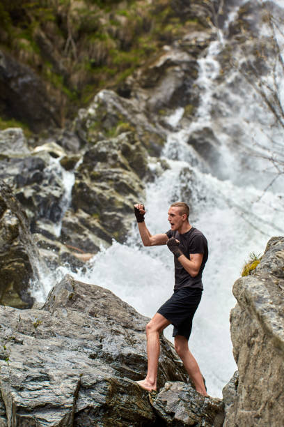 istock Muay thai fighter training by the waterfall 1153245087