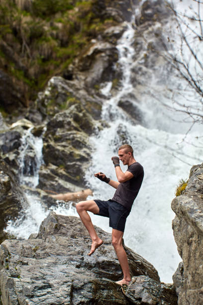 istock Muay thai fighter training by the waterfall 1153245088