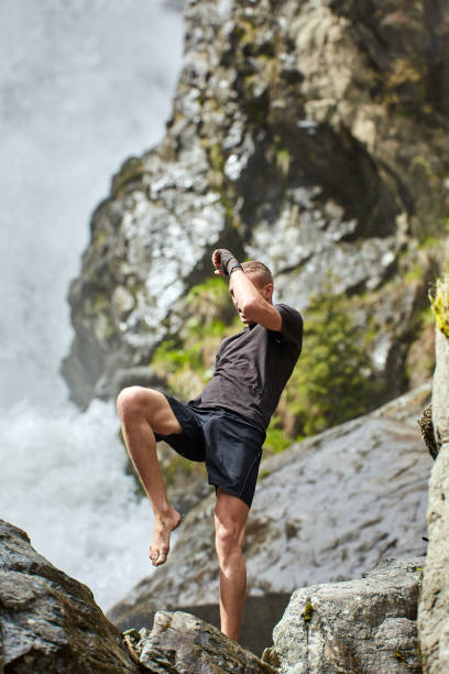 istock Muay thai fighter training by the waterfall 1153245090