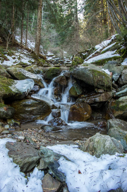 istock Half frozen river streams and weterfalls 1153245293