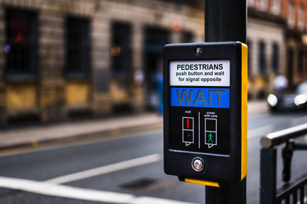 istock Pedestrian Crossing button that says 'Wait' in a city with a blurred background 1153245489