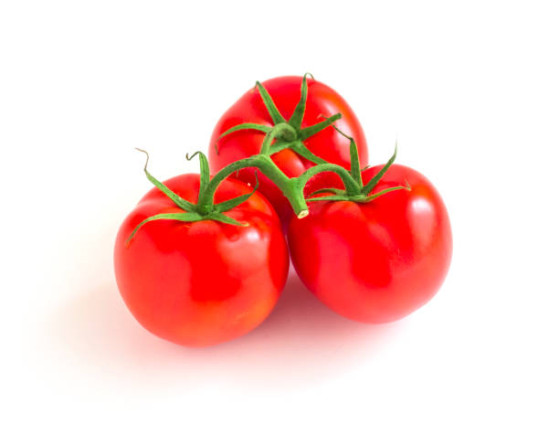 istock three tomatoes on a branch isolated on a white background 1153246192
