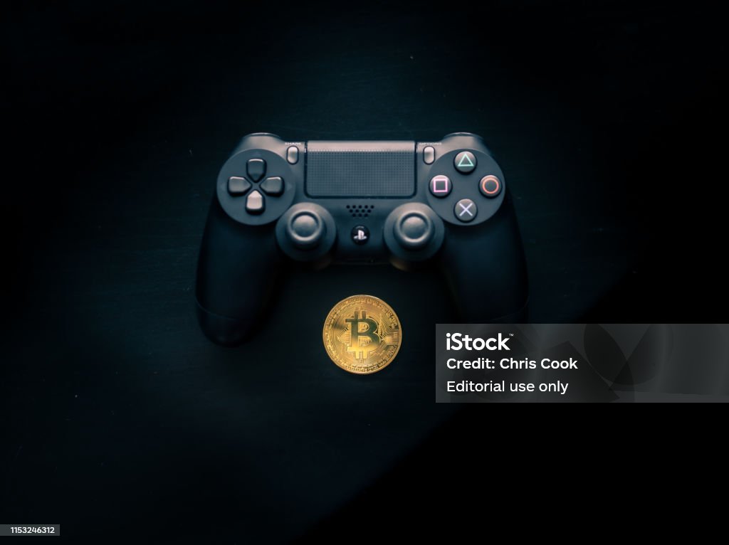 Bitcoin Sitting Underneath A Playstation Controller Stock Image Now - iStock