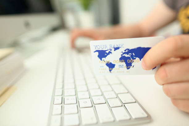 istock Male hand hold plastic bank card aganist 1153248962