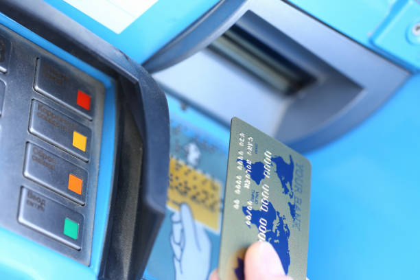 istock Male hand hold credit card aganist ATM 1153249061