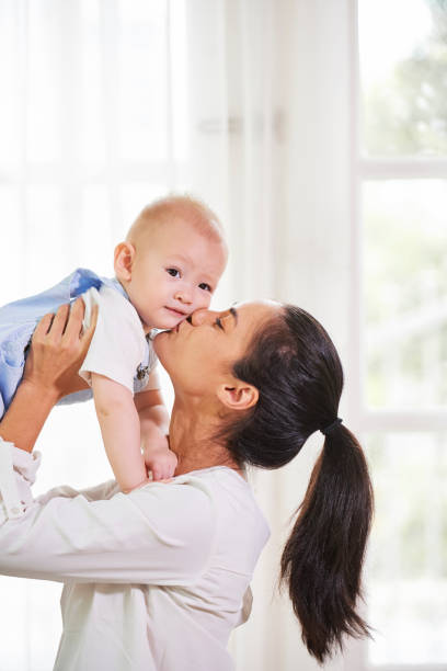 istock Mother kissing kid 1153249976