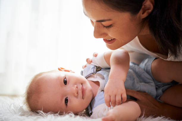 istock Mother looking at adorable baby 1153250151