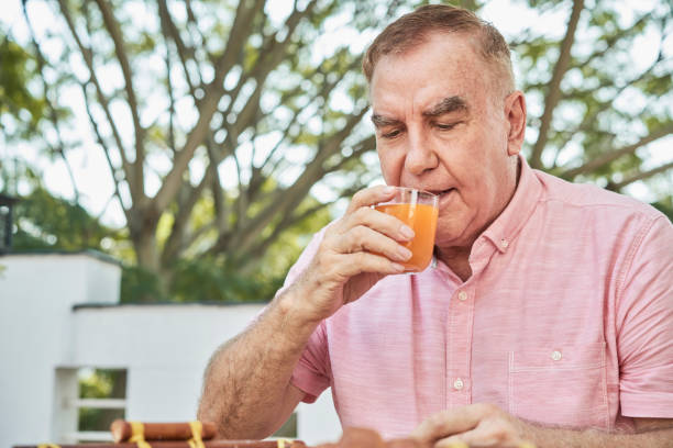istock Senior man drinking orange juice 1153250876