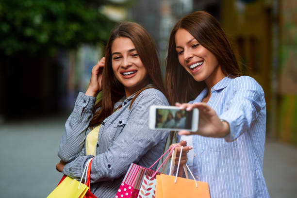 istock Two Female Friends Making Selfies after Shopping 1153251738