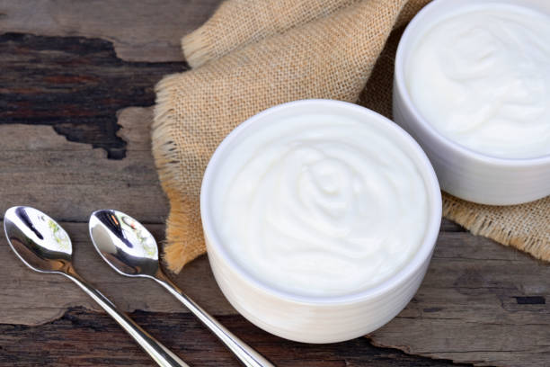 istock Yogurt  in white glass wood background. 1153253701