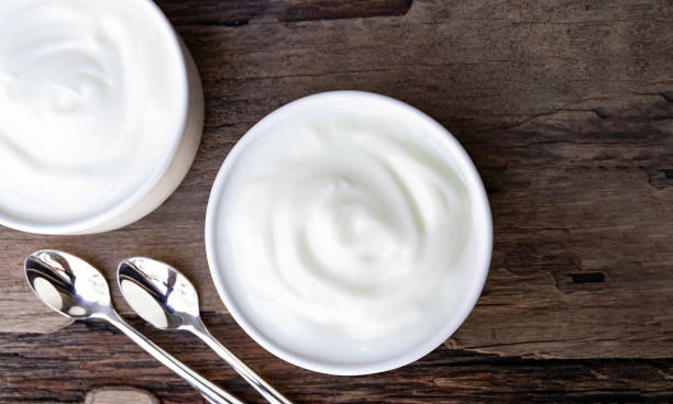 istock Yogurt  in white glass wood background. 1153254624
