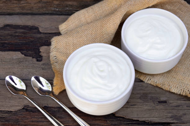 istock Yogurt  in white glass wood background. 1153254638