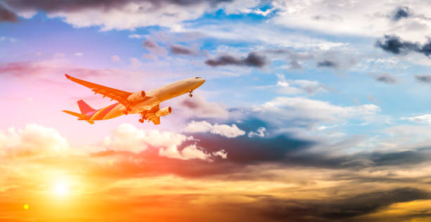 istock Airplane in the sky at sunrise 1153256130