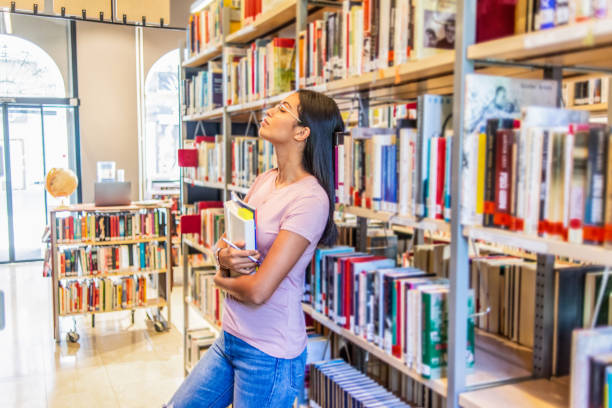 istock young woman taking a break from studying in the library 1153256467