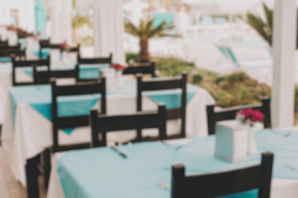 istock Abstract blur interior of a modern resort restaurant with blue tablecloths for background. 1153259095
