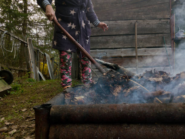 istock Woman burning household rubbish 1153260309