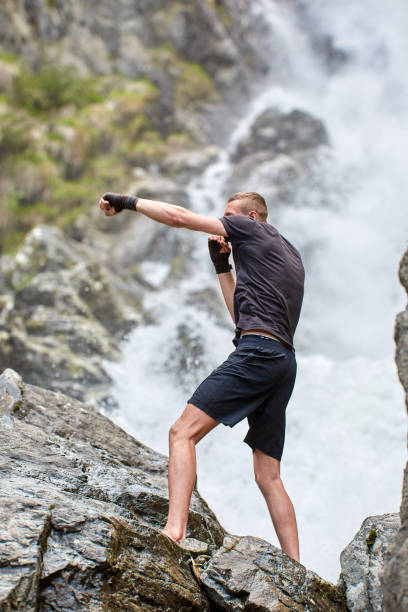 istock Muay thai fighter training by the waterfall 1153261389