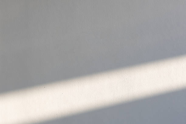 istock simplicity empty white cement wall with line of sun light and shadow at afternoon. used for template, background or texture. 1153261716