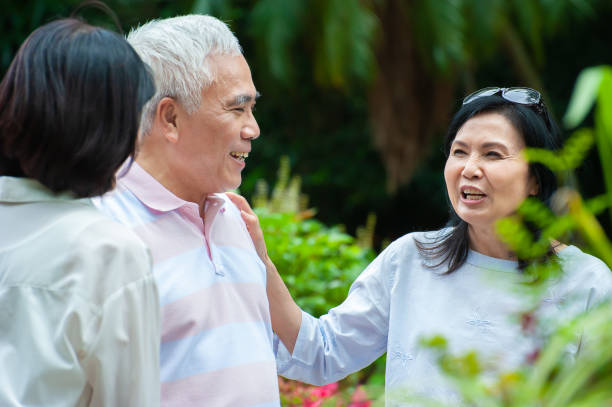 istock Three senior adults enjoy good fellowship in the park 1153261742