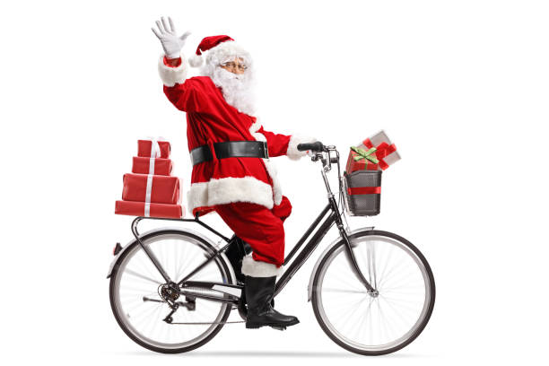 santa claus carrying presents on a bicycle and waving - bicycle isolated basket red imagens e fotografias de stock