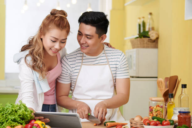 istock Couple following meal recipe 1153262003