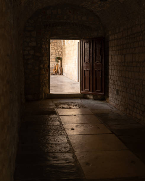istock Open door and alley of a monastery 1153262677