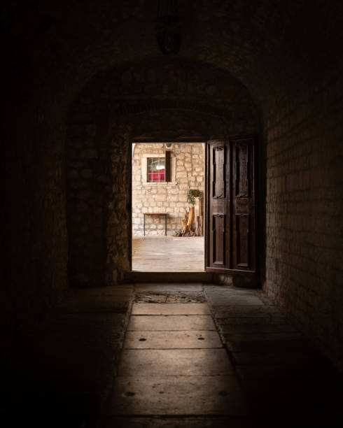 istock Open door and alley of a monastery 1153262818
