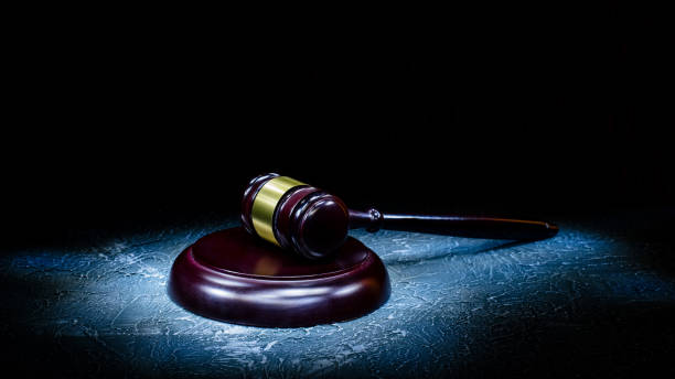 istock Judge's gavel lies on a stone table. 1153267962
