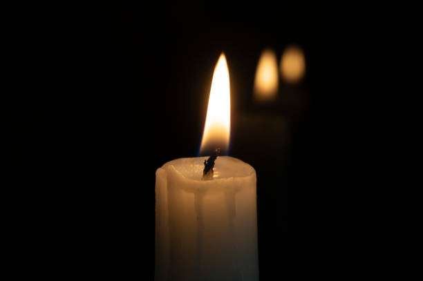 istock Close up of orange wax candle flame 1153269420