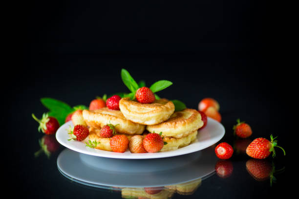 istock fried sweet pancakes with ripe strawberries in a plate 1153269788