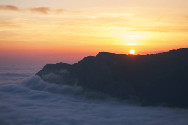 istock beautiful sunset above the clouds in the mountains. 1153271000