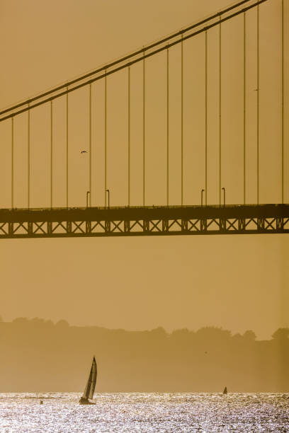 The Golden Gate Bridge in San Francisco California in late afternoon golden light seen from the Embarcadero